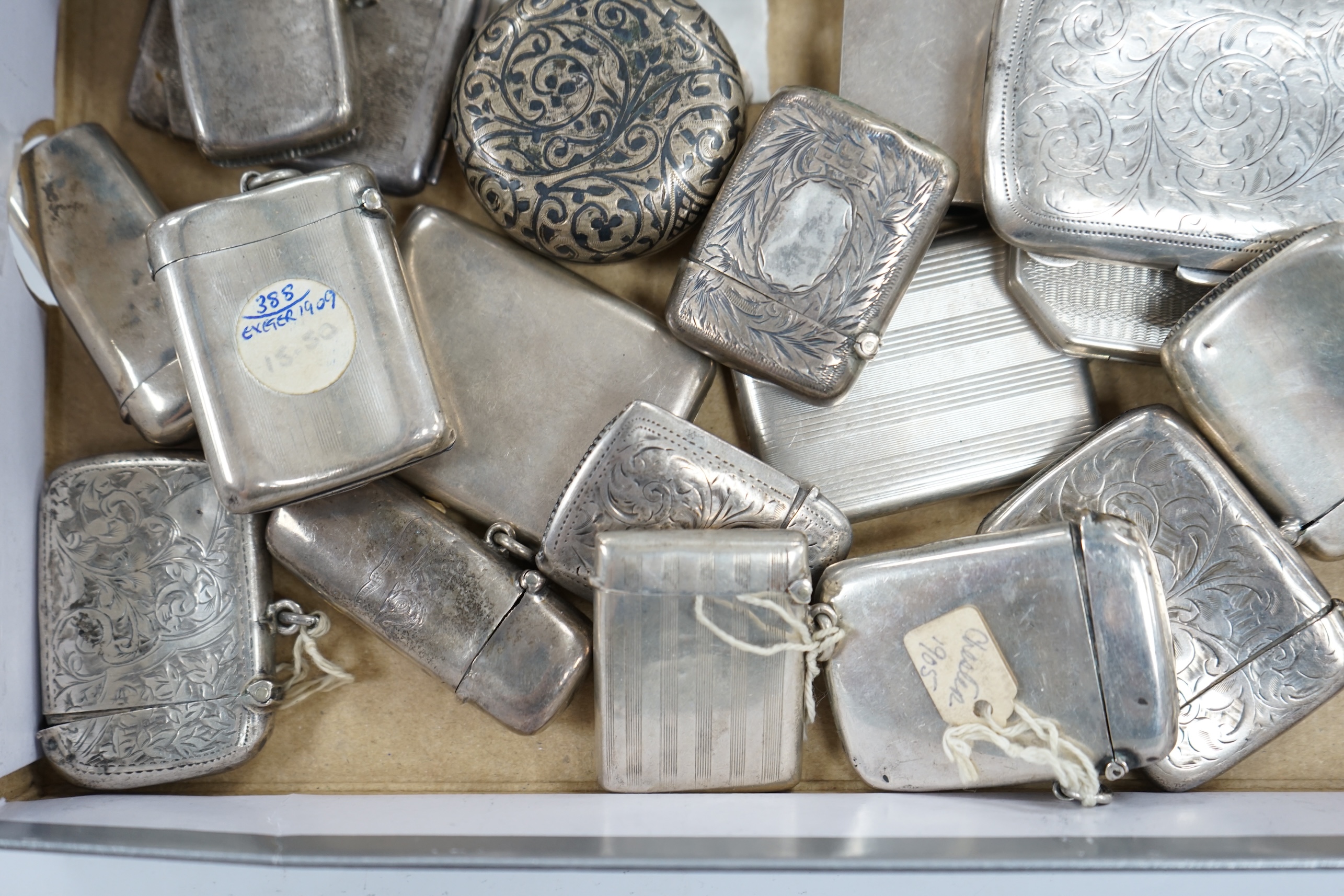 A collection of twenty four assorted silver vesta cases, eight cigarette cases, two match sleeves and a late 19th century Russian 84 zolotnik niello small tobacco box. Condition - poor to fair